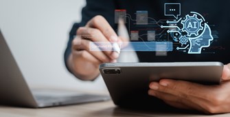 man's hands using laptop and tablet with floating AI elements