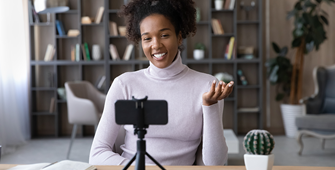 Woman recording video on phone using stand