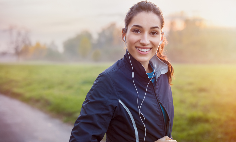 Young woman jogging wearing headphones